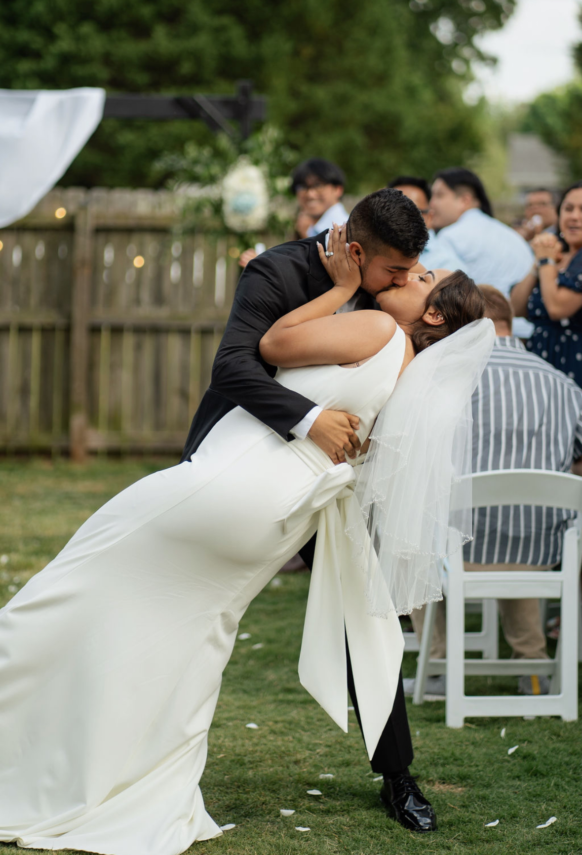First kiss between bride and groom — wedding planned by Keely + Co.